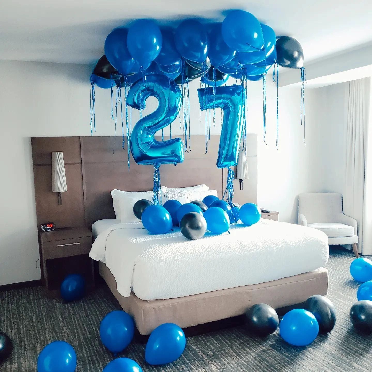 Blue balloon hanging on wall of room