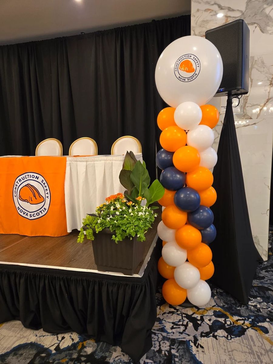Orange, navy and white logo column beside a head table