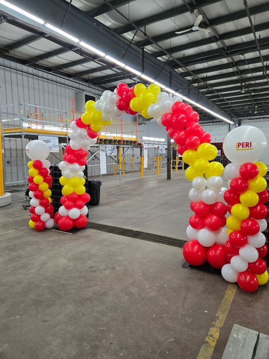 Red, yellow and white arch with columns in a warehouse
