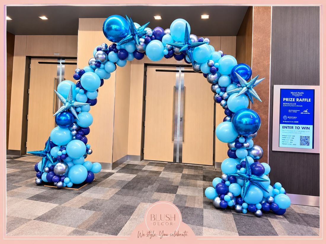Light blue, royal blue and silver organic arch with blue starbursts at a Mental Health Foundation event
