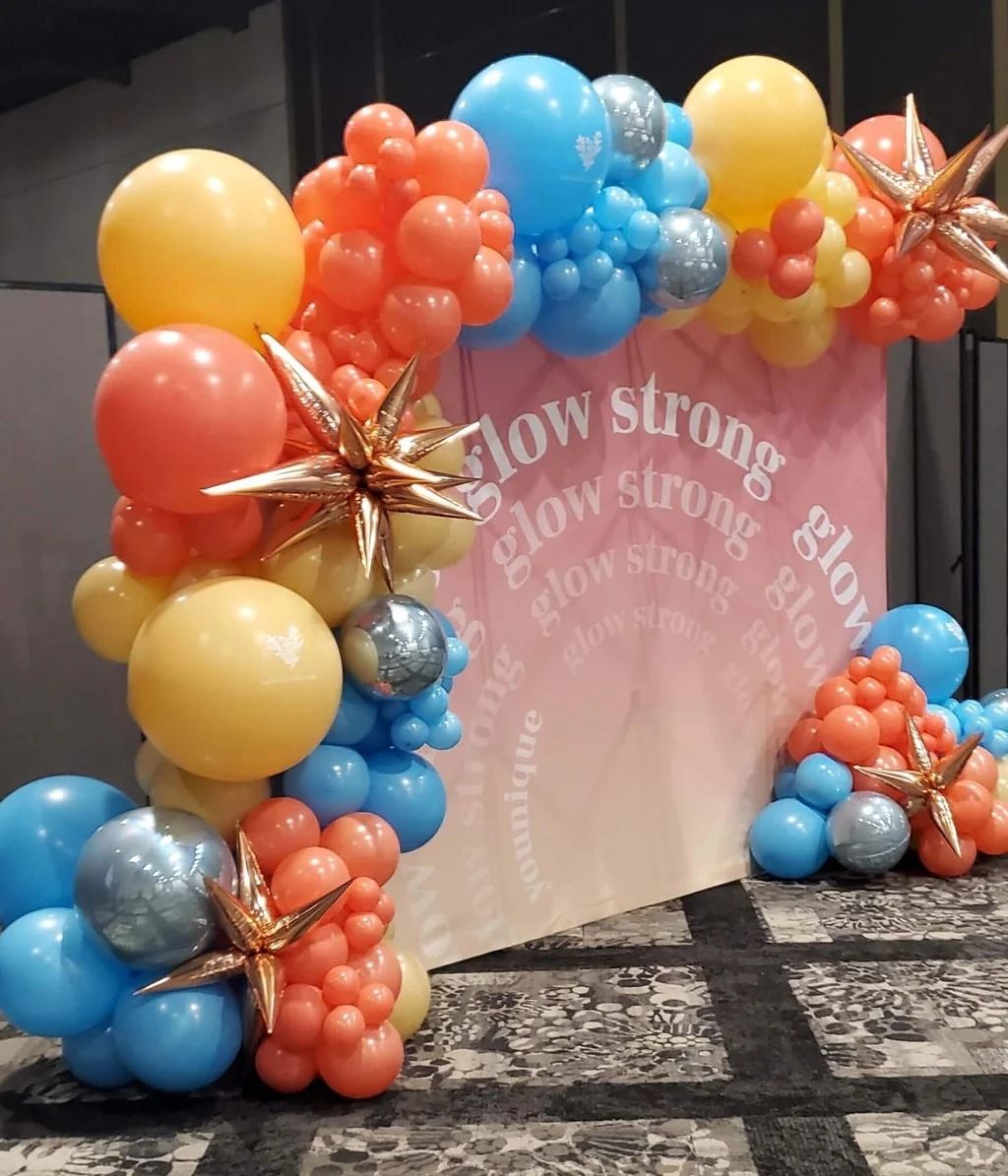 Coral, yellow and blue garland on a pink printed backdrop