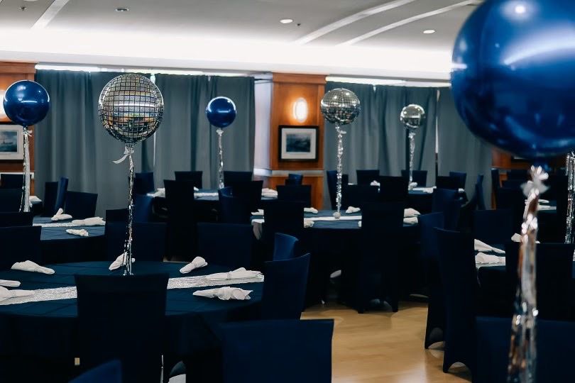 Navy and disco-ball orb centrepieces on tall stems
