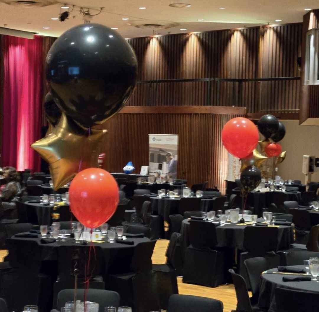 Black, red and gold helium centrepieces over banquet tables