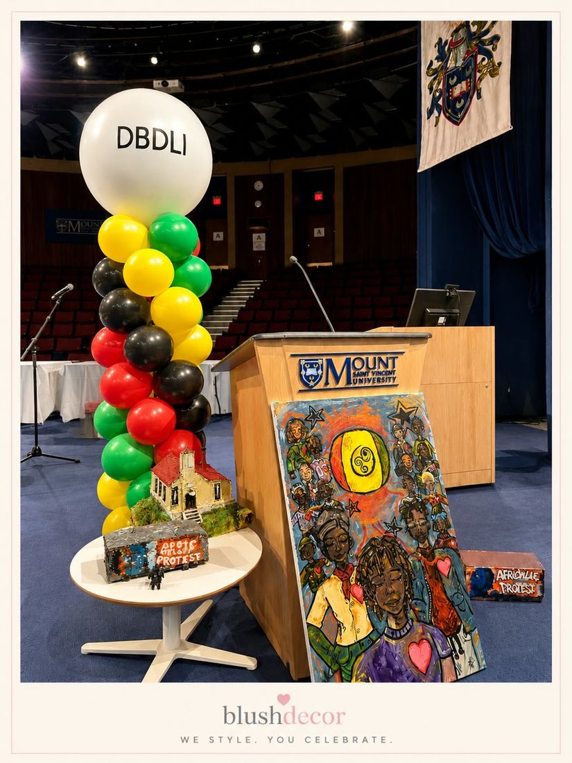 Red, yellow, green and black column with a DBDLI logo topper beside a podium