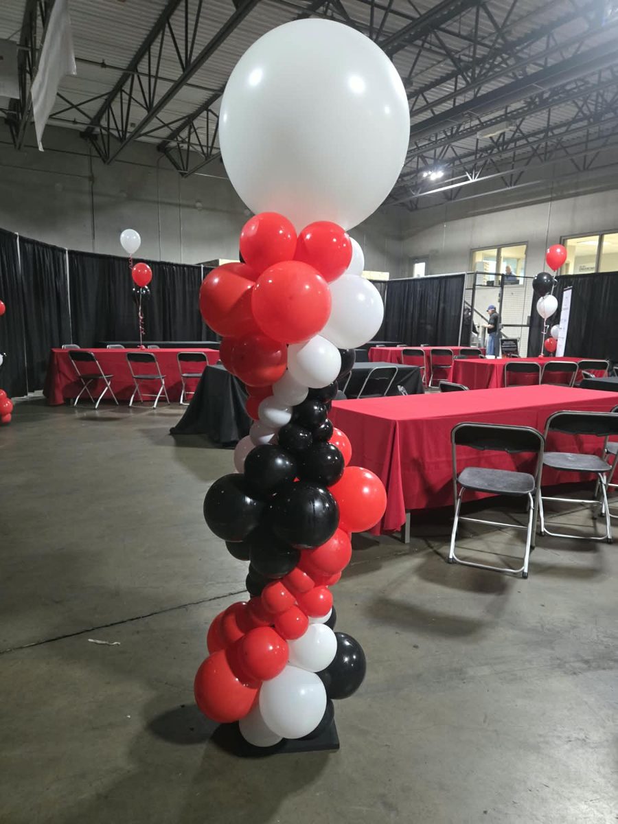 Red, black and white organic column with a jumbo white topper at a warehouse event