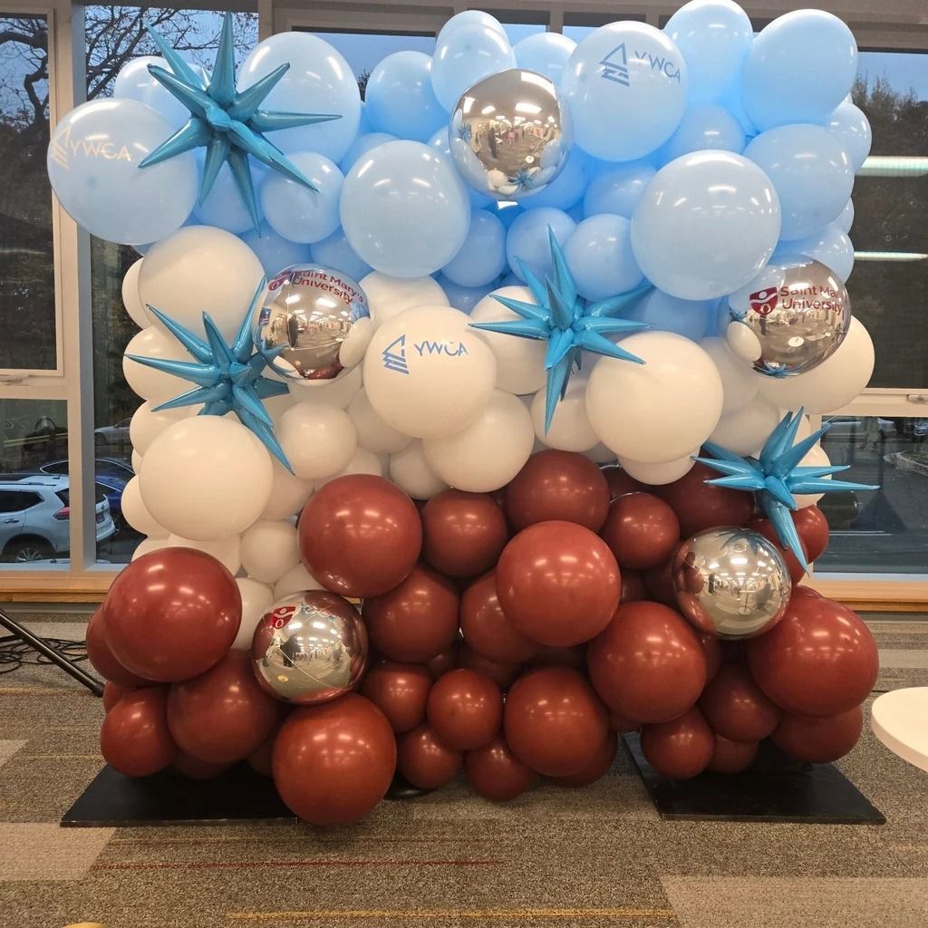 Balloon wall in light blue, white and brown with starburst accents