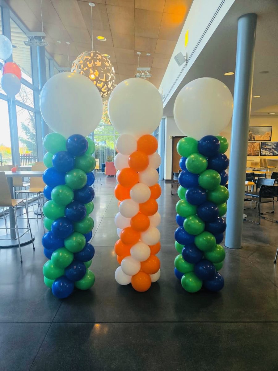 Three spiral columns in blue and green, and orange and white, with white toppers