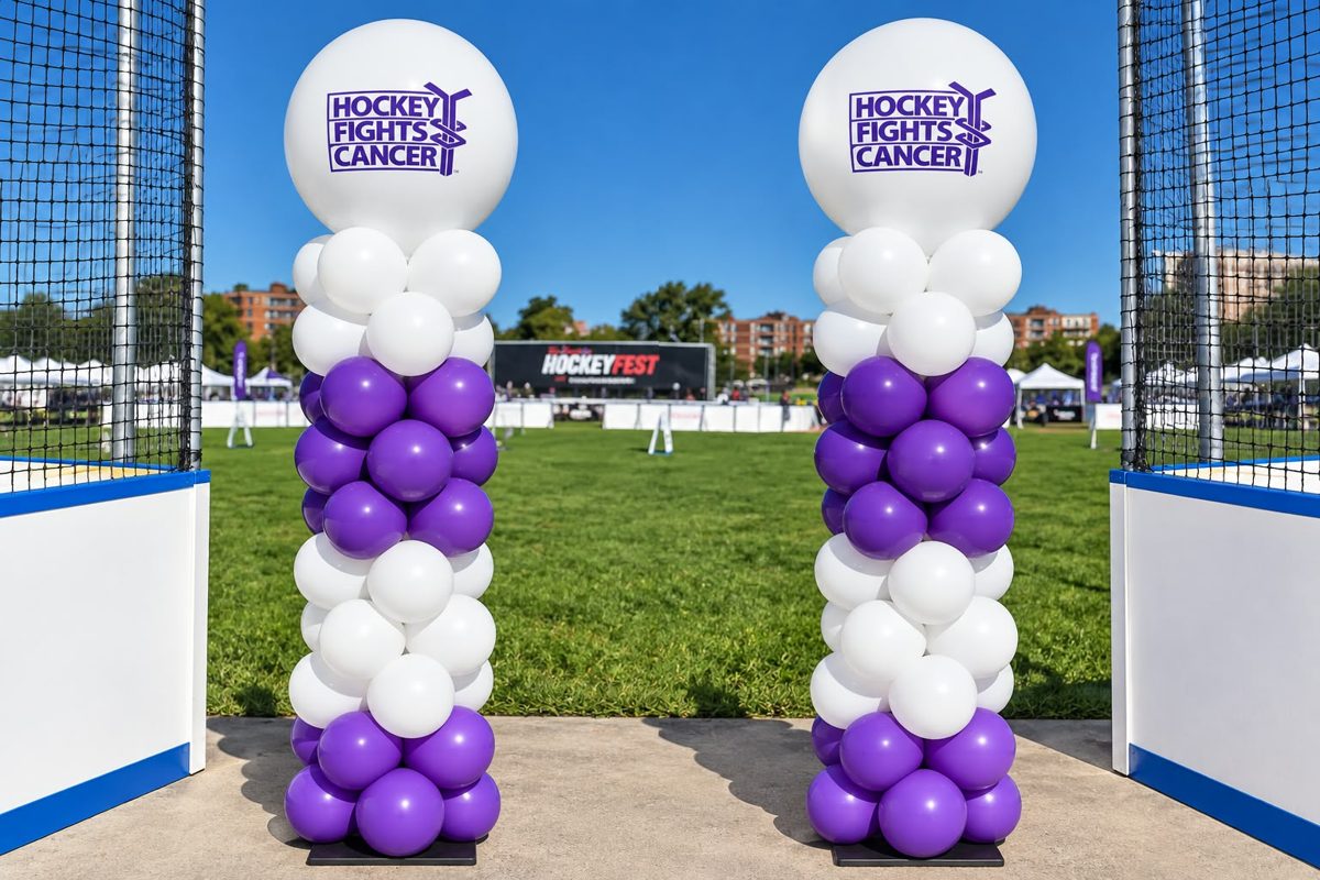 Purple and white columns with Hockey Fights Cancer logo toppers at an outdoor rink